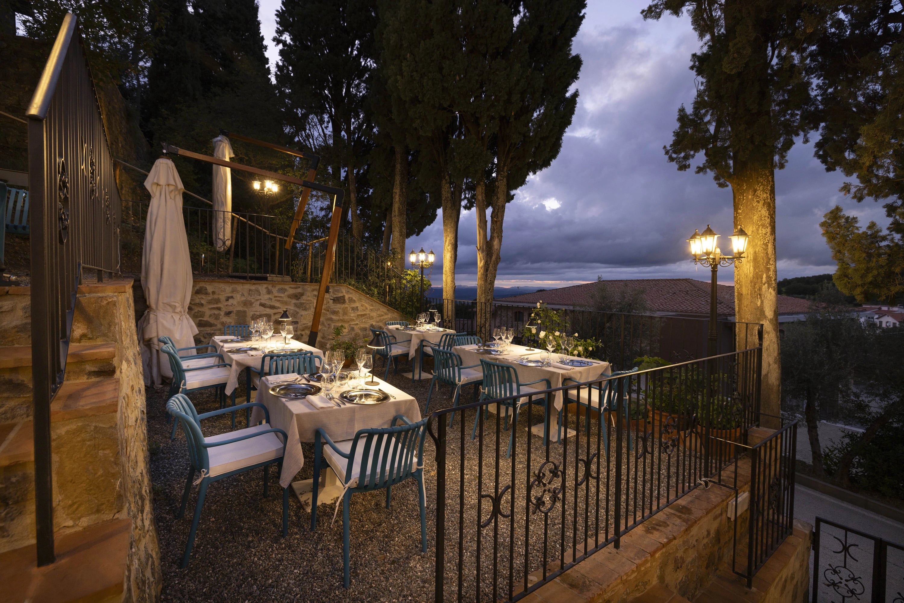 The garden terrace at Hosteria La Togata overlooking the Tuscan hills at dusk