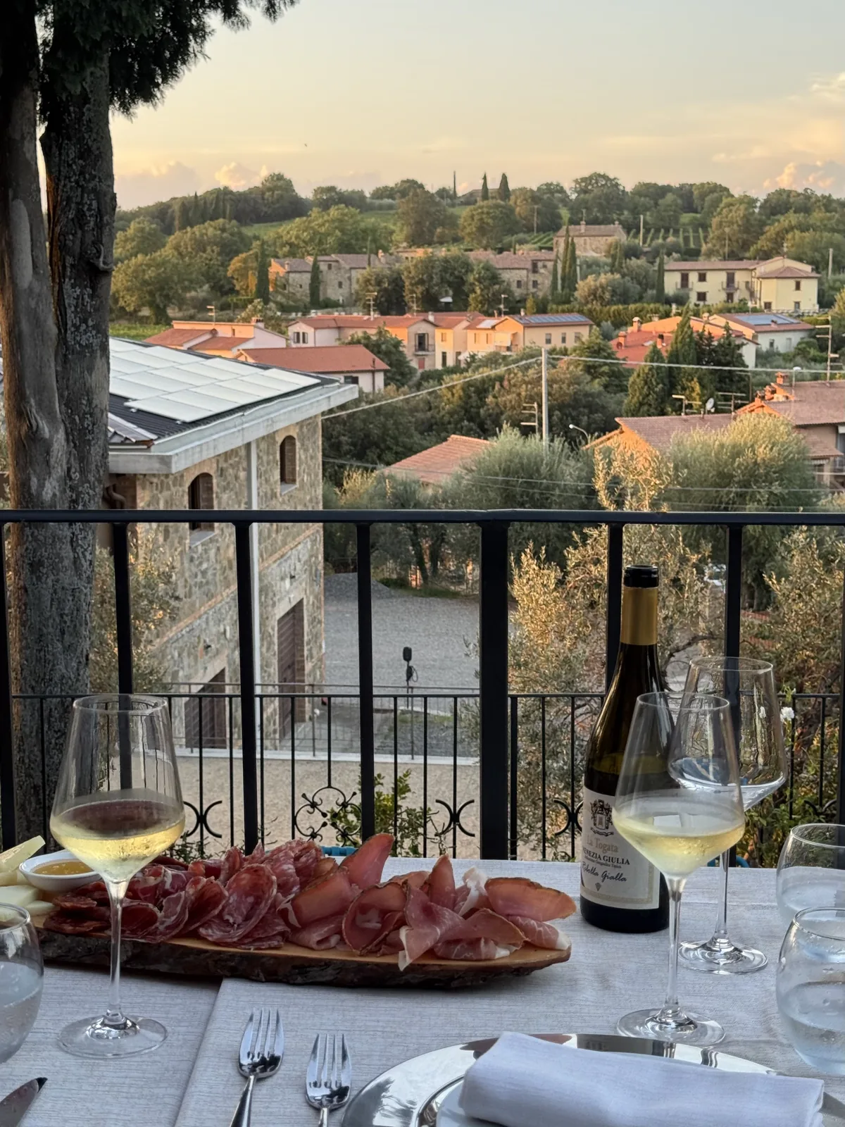 Cured meats and wine on the terrace overlooking the Tuscan hills